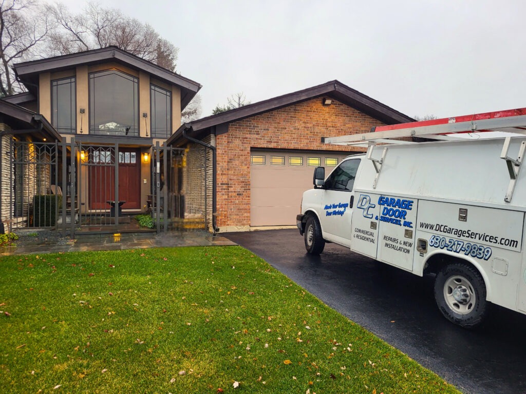 DC Garage Door & Services service truck in front of a new garage door installation