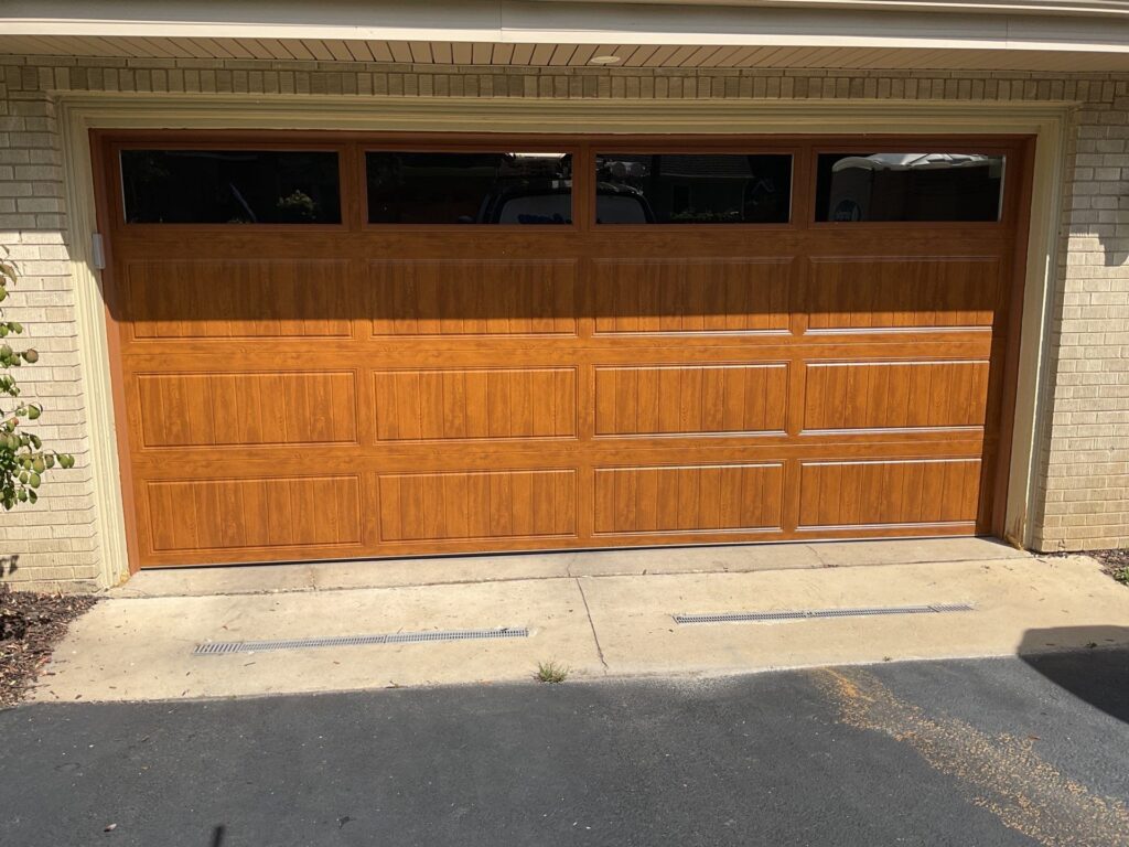 Residential garage door installation with faux wood