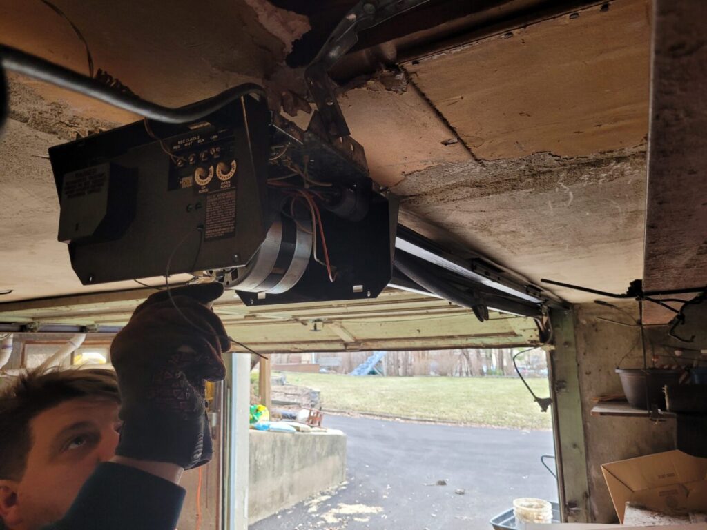 Garage door opener motor making loud squealing sound in Oak Brook, IL: a garage door opener motor unit mounted